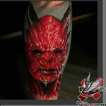 Tattoo mit einem roten Teufel als Motiv